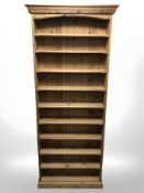 A modern pine open bookcase, 85 cm W x 22 cm D x 204 cm H.