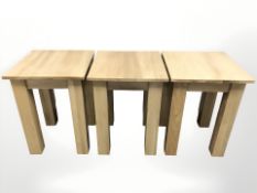 A set of three contemporary oak veneered lamp tables, width 45 cm.