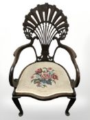 A mahogany open armchair on pad feet,