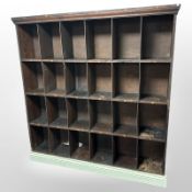 A set of late Victorian pigeon hole shelves, twenty four compartments on painted base,