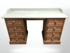 A painted pine twin pedestal desk, 140 cm W x 50 cm D x 85 cm H.