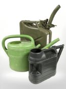 A metal 20 litre Jerry can and two watering cans