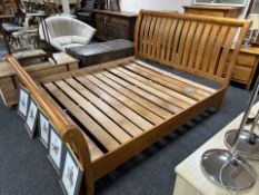 A contemporary pine 6' bed frame