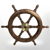 A teak and brass ship's wheel,