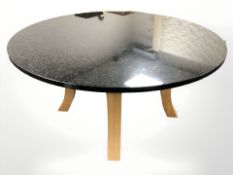 A contemporary oak and granite topped circular dining table, diameter 150 cm.