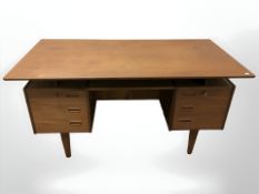 A 20th century teak twin pedestal writing desk, fitted six drawers to front,