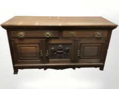 An Arts & Crafts oak sideboard,