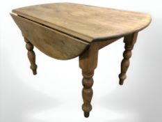 A Victorian pine drop leaf dining table,