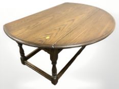A reproduction oak drop leaf coffee table,