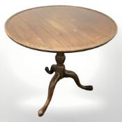 A George III style mahogany circular tripod table,