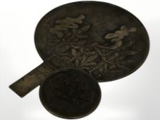 A late 19th century Japanese bronze hand mirror, length 32 cm, and a further smaller example.