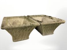 A pair of weathered concrete woven basket planters,