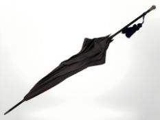 An antique silver-handled parasol