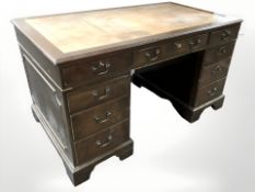 A reproduction nine drawer writing desk,