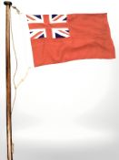 A WWII period Merchant Navy red ensign on original pole,