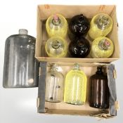 A quantity of glass demijohns.