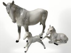 A Beswick dappled grey horse and two foals.