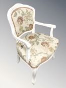 A reproduction painted armchair.