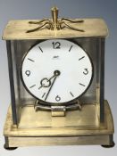 A Kundo electronic brass cased timepiece, height 24 cm.