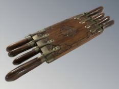 A set of eight eastern knives in carved wooden knife block, width 45 cm.