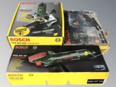 Three boxed Bosch power tools to include compact belt sander, router and jigsaw.