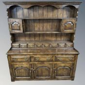 A Titchmarsh & Goodwin reproduction oak dresser, 168 cm W x 44 cm D x 192 cm H.