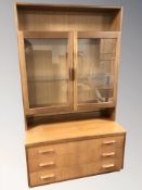 A G Plan teak glazed double door cabinet, fitted three drawers beneath,