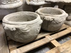 A pair of concrete garden planters,