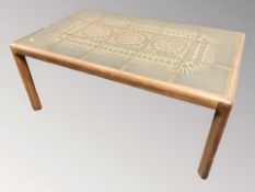 A 20th century teak coffee table with tiled inset top,