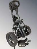 A Power Bug Pro Sport electric golf caddy, with lead and battery pack.