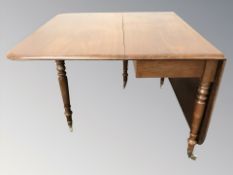 A mahogany drop leaf gate leg table, width 107 cm.
