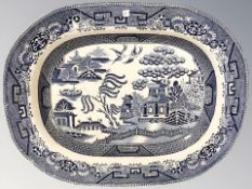A willow pattern blue and white meat plate, width 46 cm.