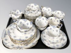 Thirty eight pieces of Crown Staffordshire tea china decorated with blue blossoms.