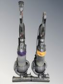 Two Dyson DC25 vacuum cleaners.