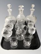 A cut crystal decanter, a further pair of etched decanters,