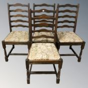 A reproduction set of four ladder back dining chairs with tapestry drop-in seats.