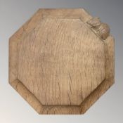 A Robert 'Mouseman' Thompson of Kilburn octagonal oak teapot stand, with carved mouse signature,