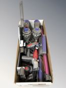 Two Dyson stick vacuum cleaners and various attachments.