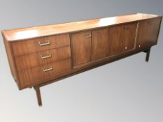 A 20th century G Plan teak sideboard, fitted cupboards and drawers, designed by E Gomme,