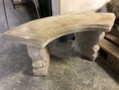 A concrete twin pedestal crescent shaped garden bench,