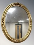 A reproduction gilt framed oval mirror,
