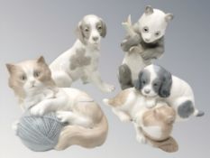 Four various Nao figures of puppies, a cat and a panda, tallest 16 cm.