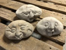 Three concrete happy face garden stones,