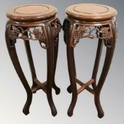 A pair of reproduction carved hardwood Chinese jardiniere stands, height 81 cm.