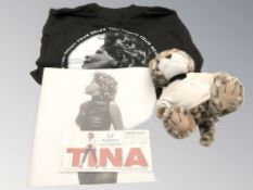 A group of Tina Turner collectibles including t-shirt, soft toy, booklet, concert tickets.