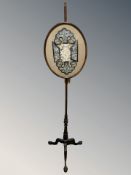 A mahogany tripod pole screen on claw and ball feet,