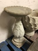 A concrete garden bird bath,