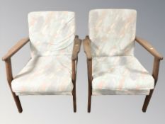 A pair of 20th century teak framed lounge armchairs,