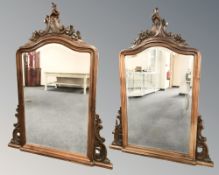 A pair of reproduction carved walnut over mantel mirrors, each 117 cm W x 150 cm H.