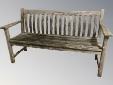 A weathered Alexander Rose teak garden bench, length 151 cm.